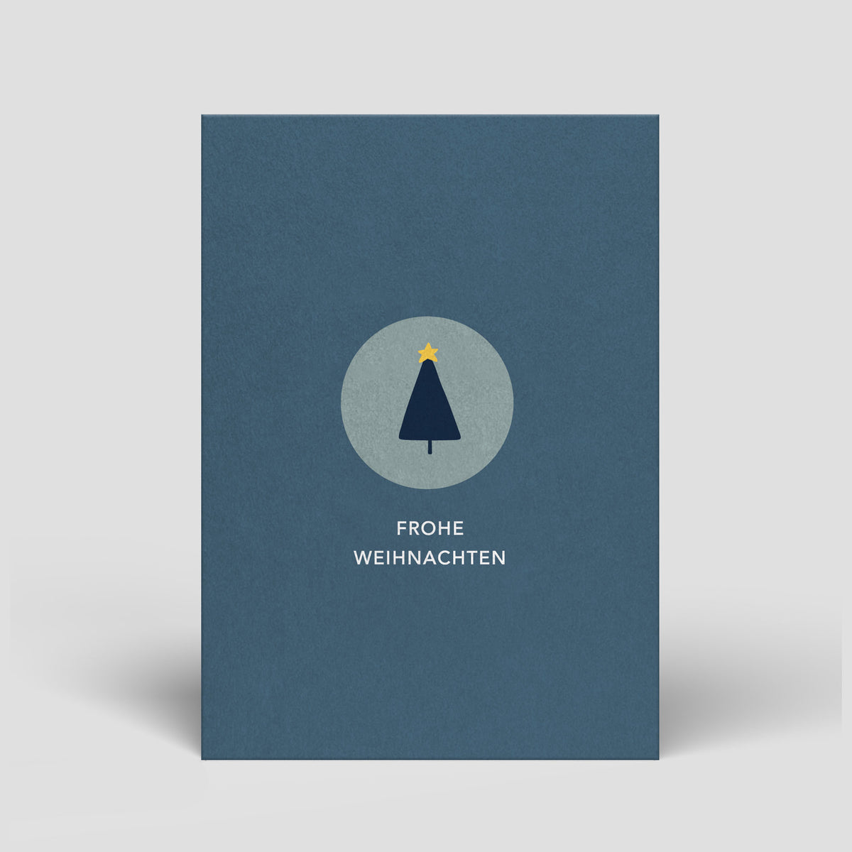 Blaue Weihnachtskarte mit Tannenbaum-Symbol und Text „Frohe Weihnachten“